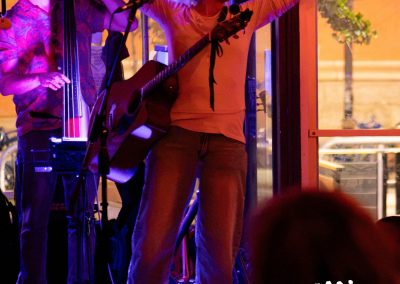 woman with her arms extended performing on stage